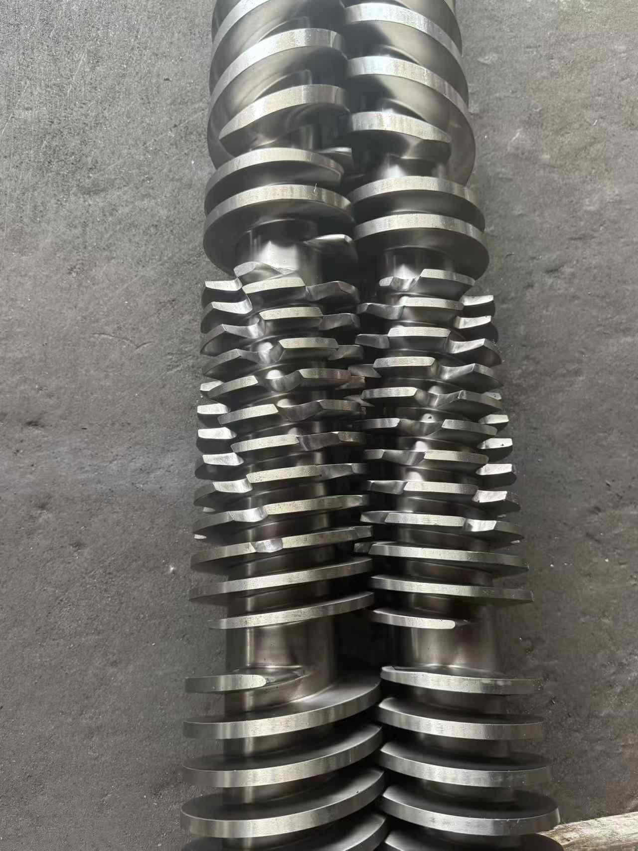 Close-up of the twin screw of a twin-screw extruder