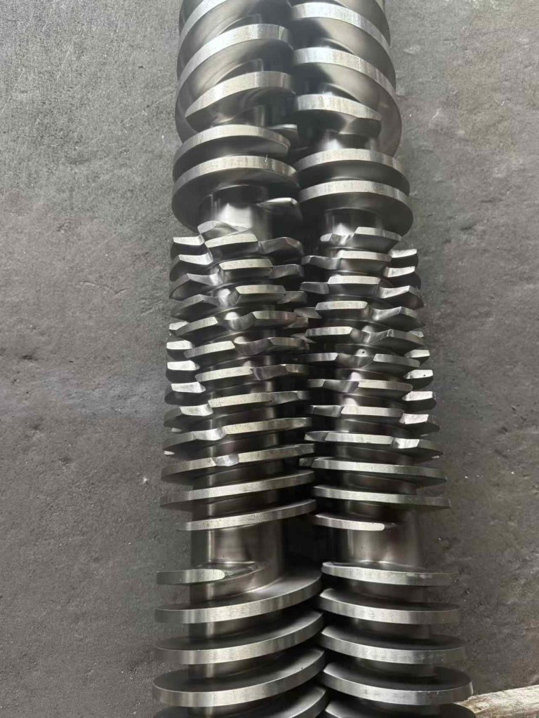 Close-up of the twin screw of a twin-screw extruder